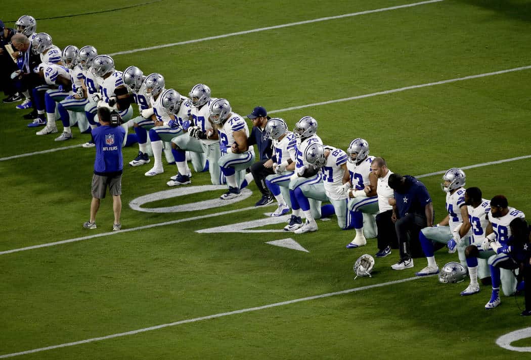 Football players kneeling