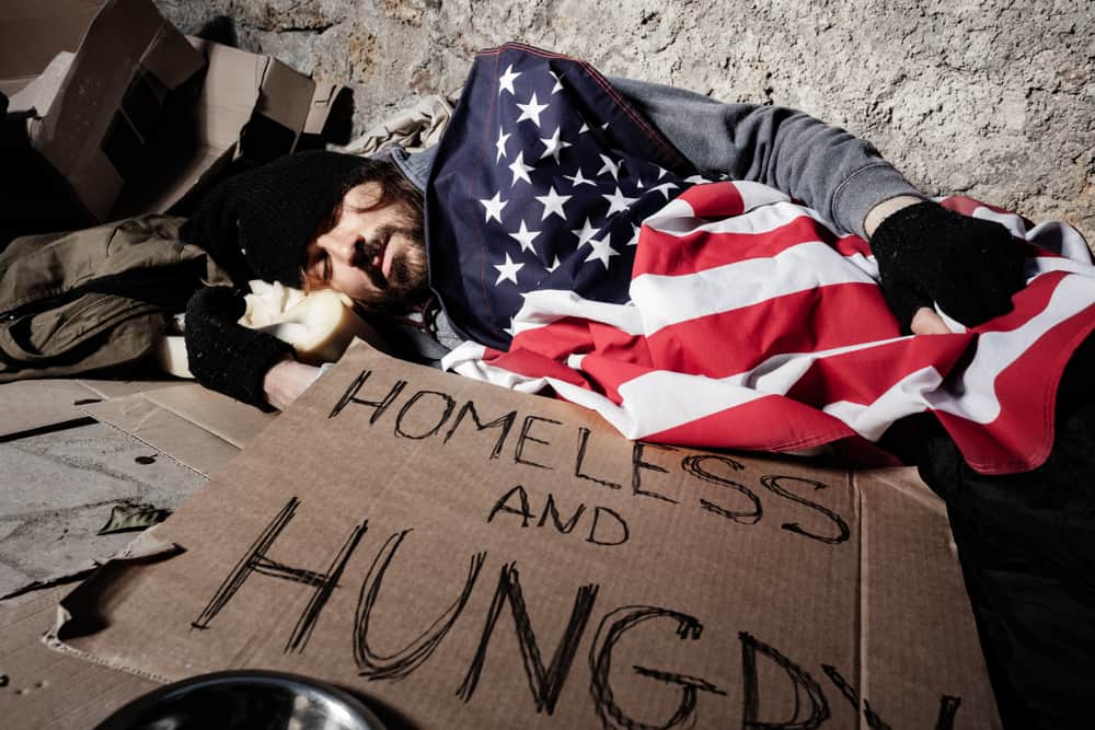 Homeless Man Sleeping with American Flag