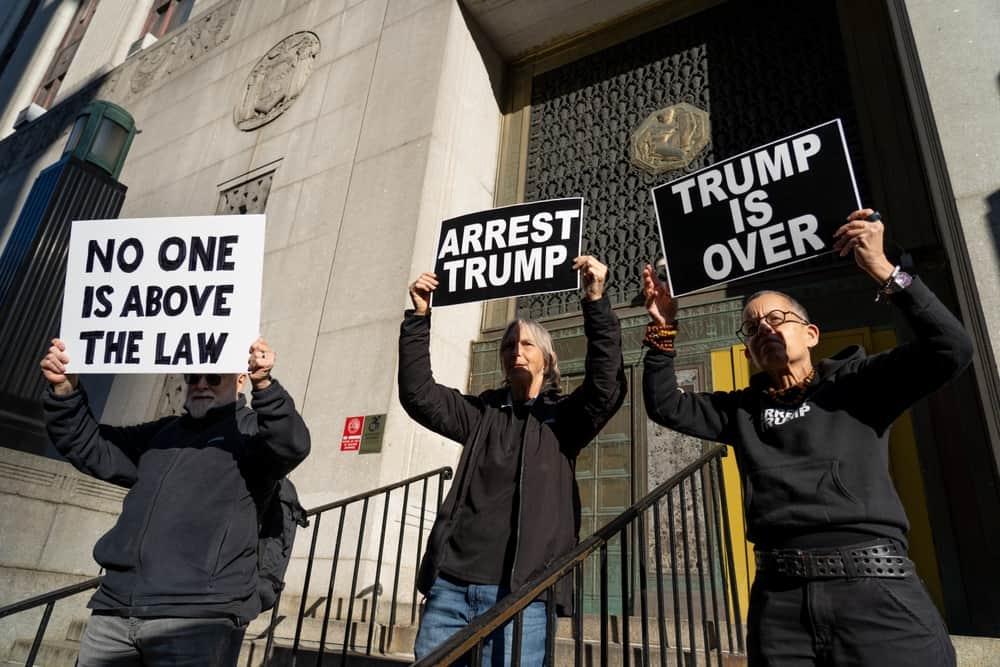 Protestors with signs about Trump arrest
