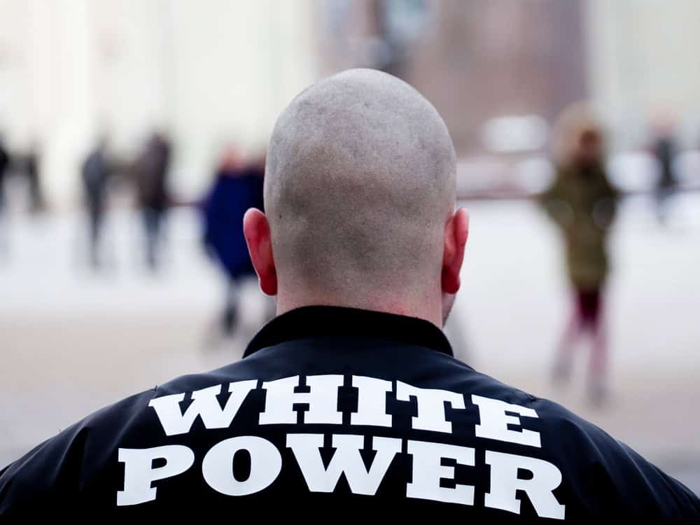 White man with white power written on his back