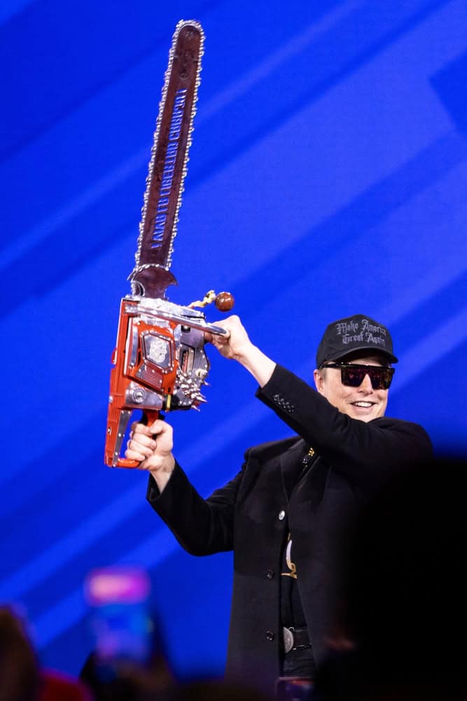 Elon Musk with a chainsaw