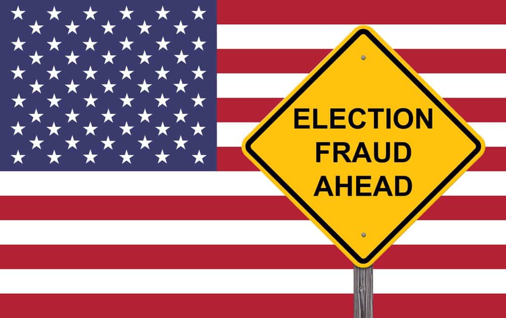 American Flag with a caution sign in front of it saying "Election Fraud Ahead"