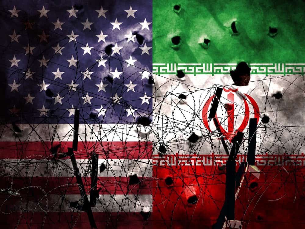 The Flags of the USA and Iran transfixed behind some barbed wire