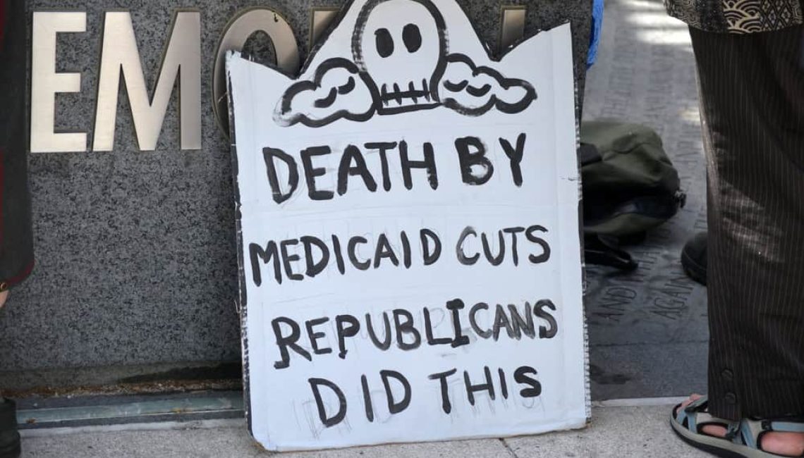 Sign saying "Death by Medicaid Cuts - Republicans did this"