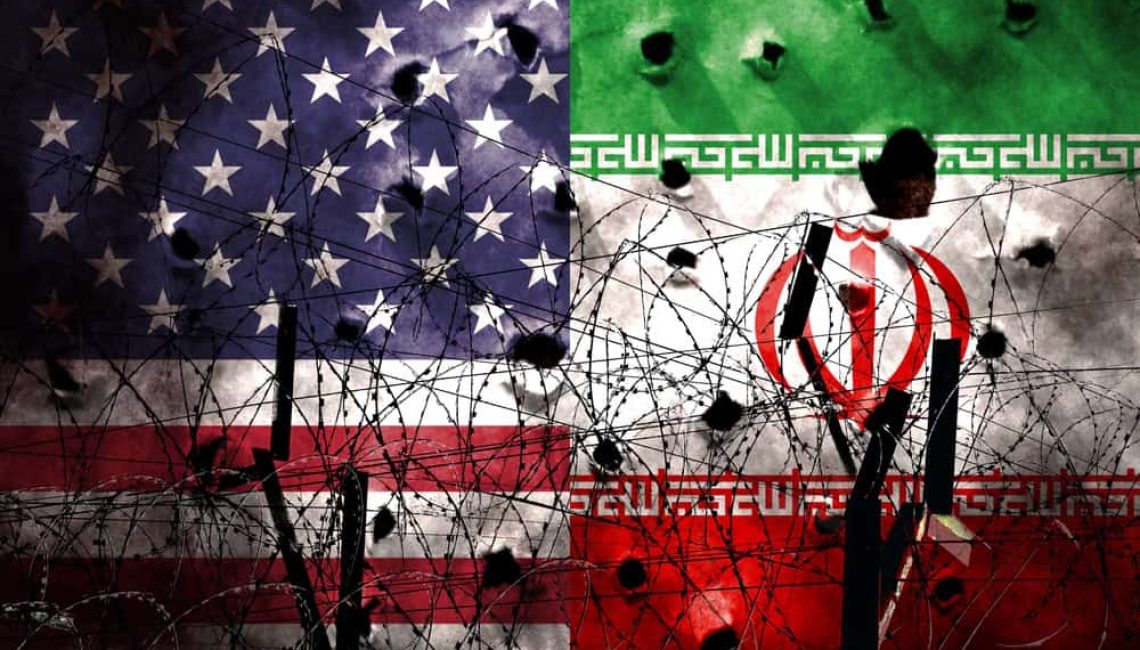 The Flags of the USA and Iran transfixed behind some barbed wire