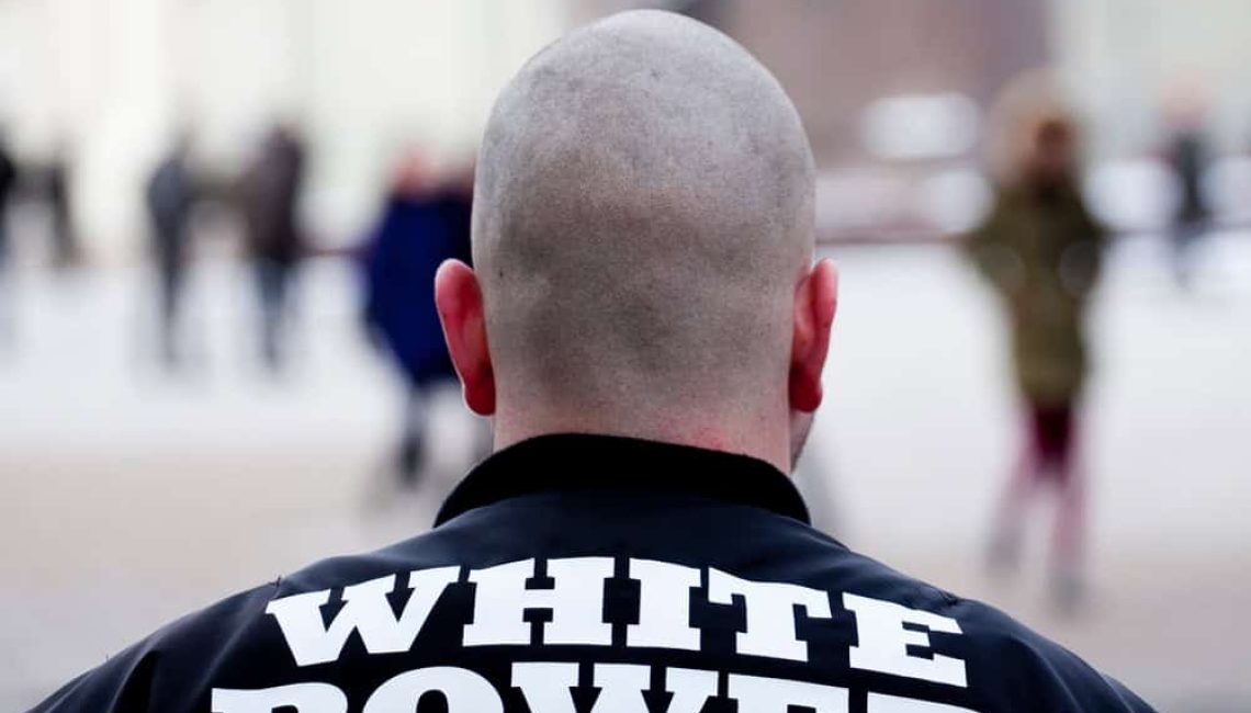 White man with white power written on his back